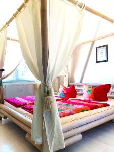 a bed with a canopy in a room at #WORLD Monteurzimmer in Schkeuditz