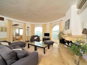 a living room with a couch and a table at Villa Vista Panorama by Interhome in Rada de Moraira