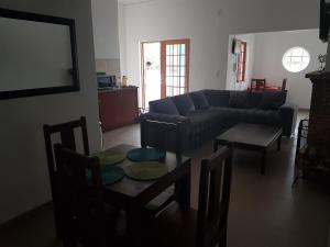 a living room with a couch and a table at Fama Lodge Single Rooms in Cape Town +5 photos