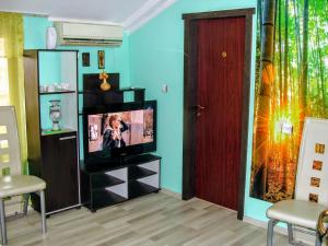 a living room with a flat screen tv on a entertainment center at Апартамент за гости"Вълчанови" in Elkhovo
