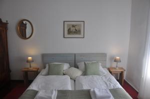 a bedroom with a bed and two tables with lamps at Ferienhaus Ilse-Bilse in Neuhausen