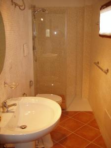 a bathroom with a shower and a sink and a toilet at Villa Franca in Pula