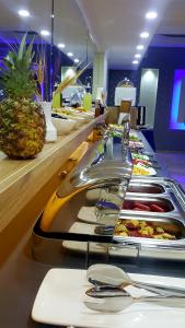 a buffet line with plates of food and a pineapple at MARİNA HOTEL in İzmir