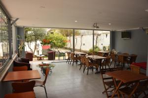a restaurant with tables and chairs and a patio at Minta Apart Hotel in Kemer