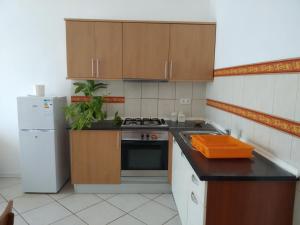 a small kitchen with a stove and a refrigerator at Good value low cost apartment second beach line in Santa Maria +11 photos