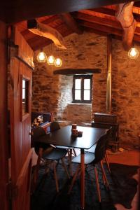 a dining room with a table and chairs at Casa Javali in Chiqueiro