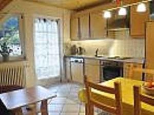 a kitchen with a table and a dining room at Vollmershof in Wolfach
