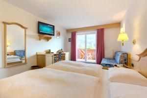 Postel nebo postele na pokoji v ubytování Hotel Piccolo