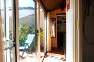 una puerta corredera de cristal que da a un patio con una silla en Appartamenti Olivuzza, en Palermo