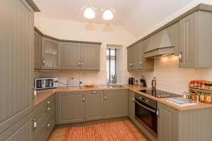 a kitchen with gray cabinets and a counter top at Garra Cottage in Drogheda