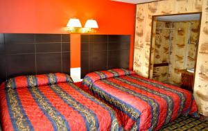 Postel nebo postele na pokoji v ubytování Andrews Motor Inn
