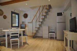 a living room with a table and a staircase at Apartment Gordana in Cres