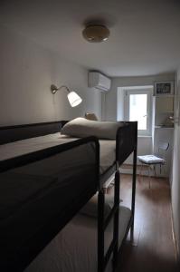 a bedroom with two bunk beds and a chair at Apartment Gordana in Cres
