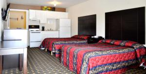 a hotel room with two beds and a kitchen at Andrews Motor Inn in Andrews