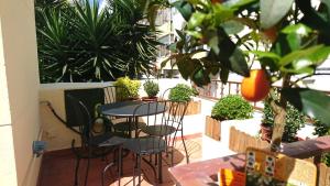 a patio with a table and chairs and plants at Casa do Alfaiate ® Home&Breakfast in Almada