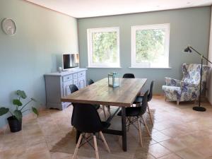 a dining room with a wooden table and chairs at Ferienhaus LOOP IN in Ribnitz-Damgarten