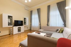 a living room with a couch and a tv at Golden Star in Zagreb