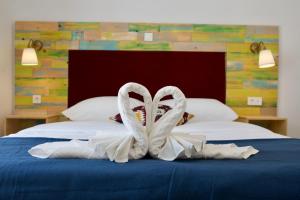 a white ribbon sitting on top of a bed at Boho House in Pakoštane