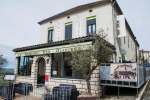 a building with a sign on the front of it at Logis Hôtel La Bastide des Oliviers in Monflanquin