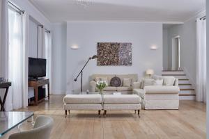 a living room with a couch and two chairs at Poseidonion Grand Hotel in Spetses