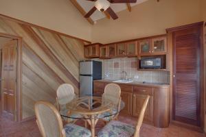 a kitchen with a glass table and a refrigerator at X'tan Ha- The Waterfront in San Pedro