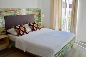 a bedroom with a bed with two pillows on it at Boho House in Pakoštane