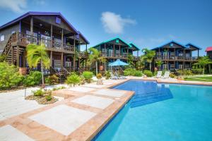 a resort with a swimming pool in front of a building at X'tan Ha- The Waterfront in San Pedro