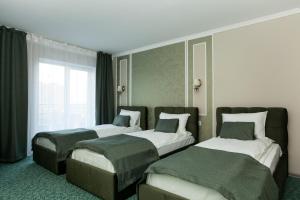 Postel nebo postele na pokoji v ubytování Mon Ami Hotel