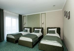 Postel nebo postele na pokoji v ubytování Mon Ami Hotel