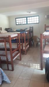a room with several bunk beds and a table at Hostel DS in Campo Grande