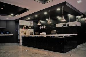 a lobby of a laiba restaurant with pendant lights at LaiLa Hotel Mexico City Reforma in Mexico City
