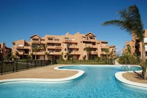 a resort with a swimming pool in front of a building at Coming Home - Mar Menor Resort in Torre-Pacheco
