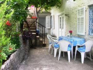 a table and chairs sitting outside of a house at Vicky Apartments in Kotor
