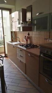 una cucina con lavandino e piano cottura forno superiore di Casa Diana a Roma