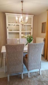 a dining room table with chairs and a chandelier at Achtern - Diek - am Strand in Zingst +18 photos