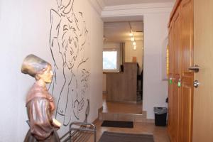 a hallway with a statue and a painting on the wall at Fewo Enzian in Bach