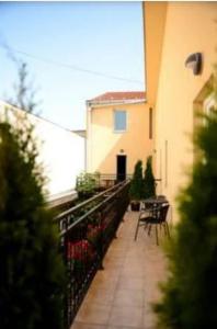 a balcony of a building with a table and chairs at Centar Novi Sad Studio No2 PARKING ON REQUEST in Novi Sad +10 photos