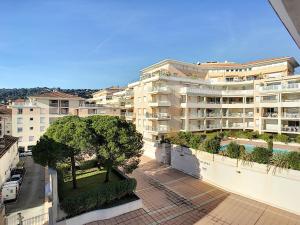 a view of a large apartment building from a balcony at Cozy Apartment sea view Air Cond in Golfe-Juan