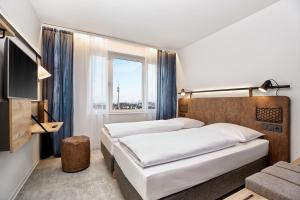 H2 Hotel München Olympiapark客房内的一张或多张床位