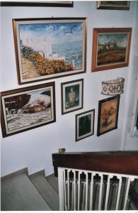 a bunch of pictures hanging on a wall at Il Giuggiolo in Calco