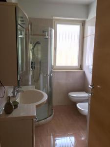 a bathroom with a sink and a shower and a toilet at Appartment Trojer in Merano