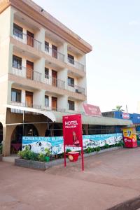 a hotel building with a sign in front of it at Hotel Millenium Kampala Zaana in Kampala