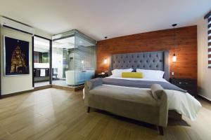 a bedroom with a large bed and a large window at Hotel La Torre San Francisco in San Francisco del Rincón
