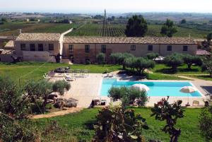 an external view of a villa with a swimming pool at Relais Casa Mirabile in Menfi