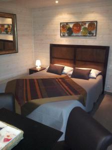 เตียงในห้องที่ Timazen Lodges Agen Sud