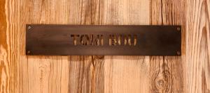 a sign on a wooden door with the words turnbull at Hotel Boutique Puig Francó - Adults Only in Camprodon