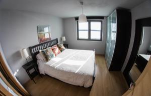 A bed or beds in a room at La Riega del Peral