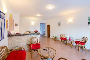 a living room with a table and chairs and a fireplace at Blue Roses in Ixia