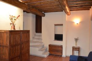 a living room with a staircase and a television at Palazzo Alle Mura in Staggia