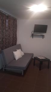 a living room with a couch and a table at Apartmán - súkromie v meste (1) in Bratislava